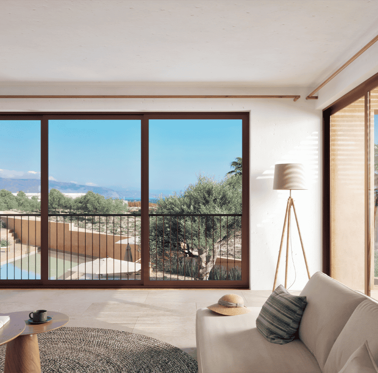 Spacious living room with large windows overlooking the sea and surrounding landscape in Maleme Resi.