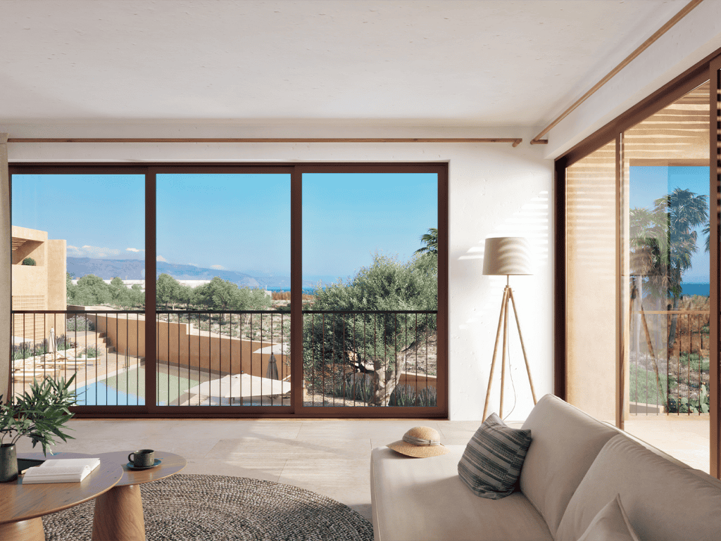 Spacious living room with large windows overlooking the sea and surrounding landscape in Maleme Resi.