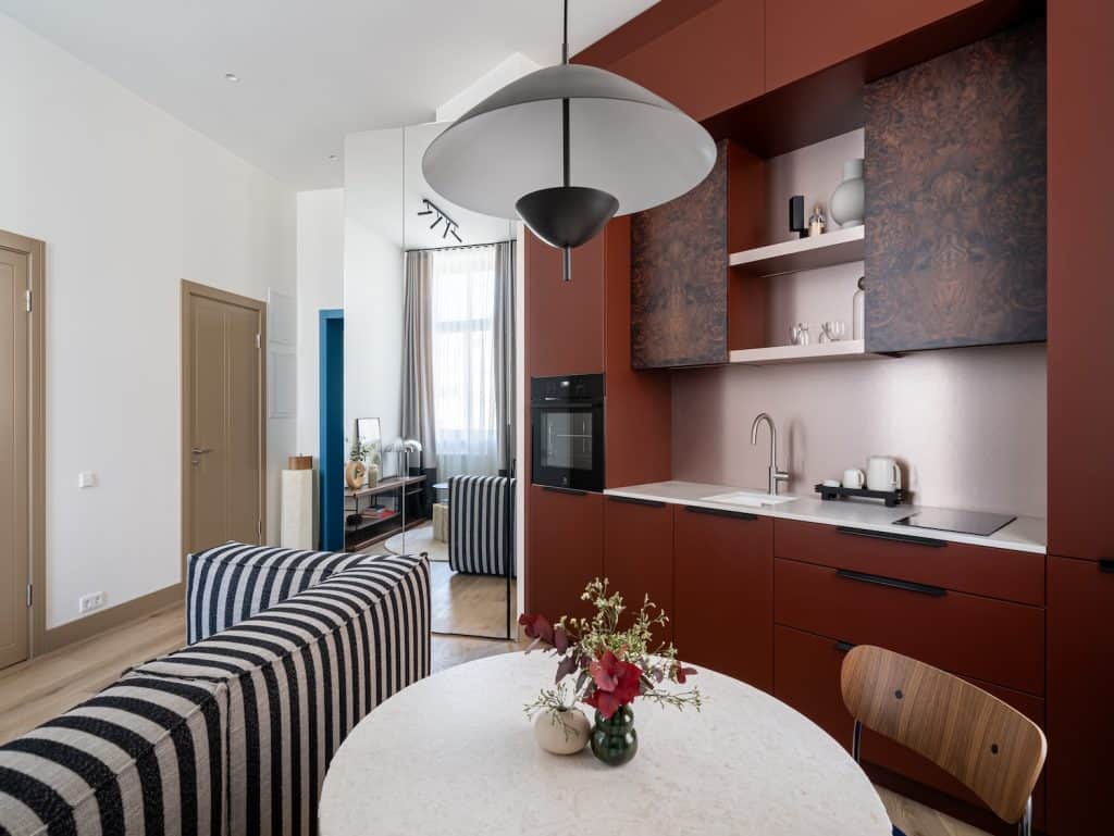 Contemporary Riga apartment kitchen with sleek cabinetry and open-plan living area.
