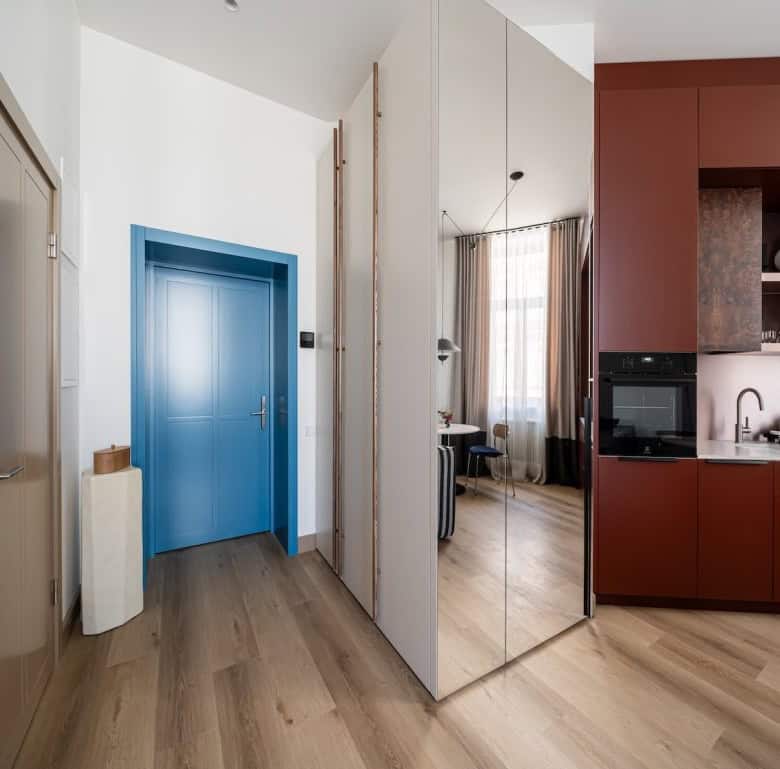 Bright Riga property with contemporary design, featuring a vibrant blue door and open-plan living sp.