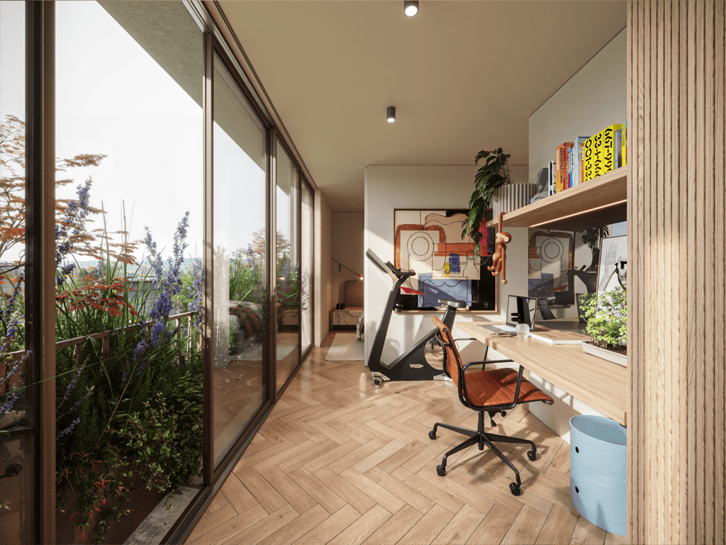 Bright interior workspace with desk, computer, and exercise bike, overlooking lush outdoor plants.