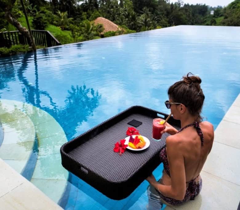 Stunning infinity pool at Amori Villas in Ubud, Bali, with lush tropical surroundings.