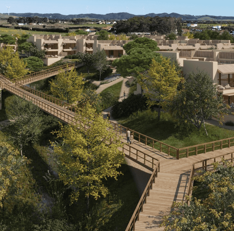 Scenic view of Porto Covo and Sines with lush greenery and modern homes in Portugal.