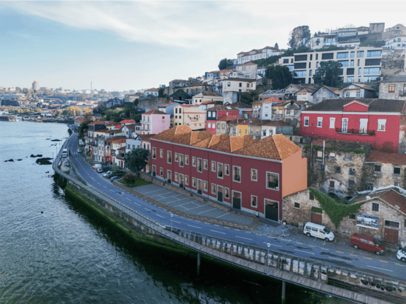 Colorful houses along the river in Porto, Portugal, showcasing vibrant architecture and scenic water.