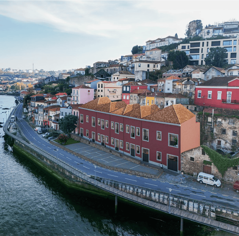 Colorful houses along the river in Porto, Portugal, showcasing vibrant architecture and scenic water.
