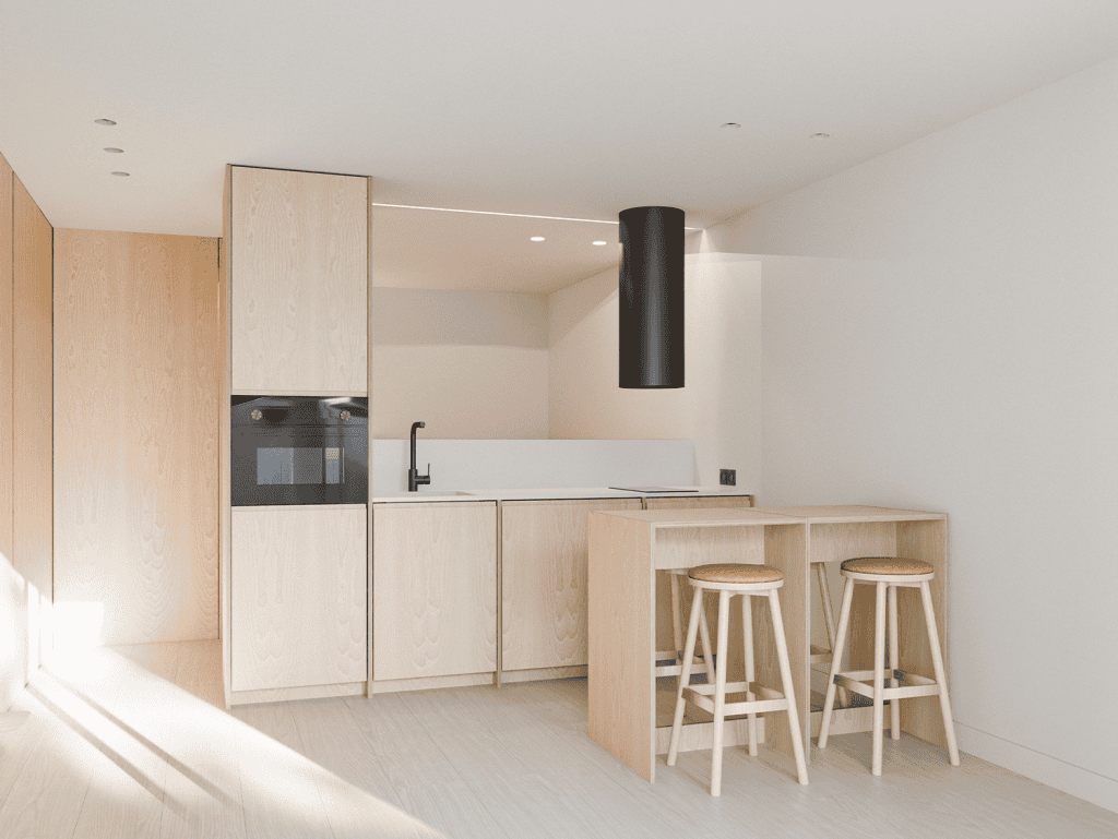 Modern kitchen with light wood cabinets and minimalist design in Pilar Apartments, Porto, Portugal.