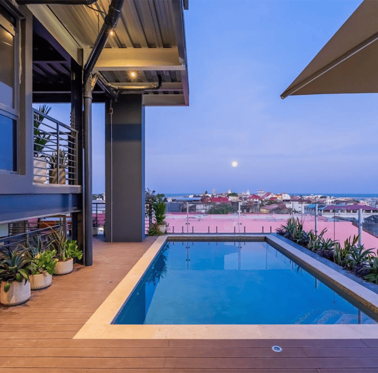 Panama City skyline seen from a balcony with a private pool at dusk.