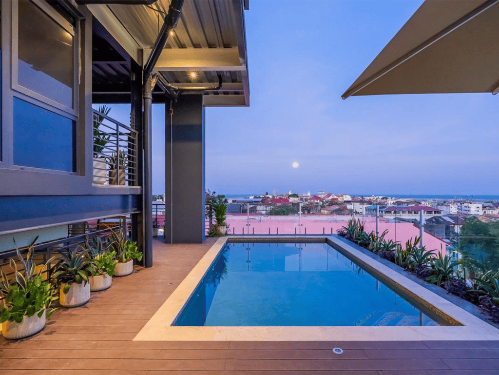 Panama City skyline seen from a balcony with a private pool at dusk.
