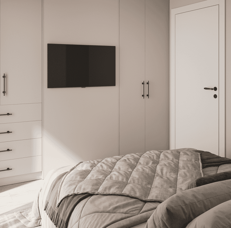 Spacious bedroom featuring a sleek built-in wardrobe and a wall-mounted TV, offering comfort and mod.
