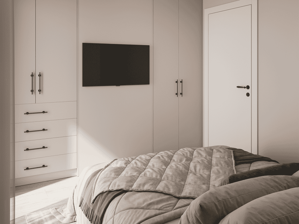 Spacious bedroom featuring a sleek built-in wardrobe and a wall-mounted TV, offering comfort and mod.