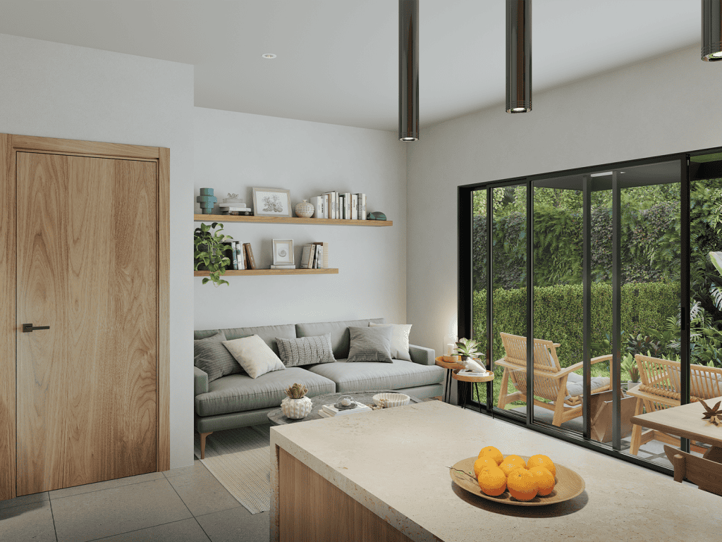 Modern living room with large glass doors overlooking lush garden in Jaco, Costa Rica.