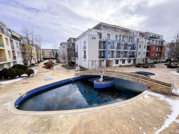 Pool view from cozy studio apartment on a sunny day.