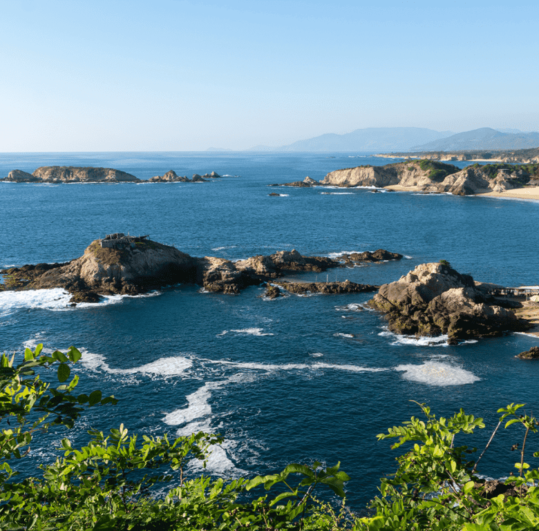 Beach coastline in Bucerias, Mexico with rocky formations and ocean views.