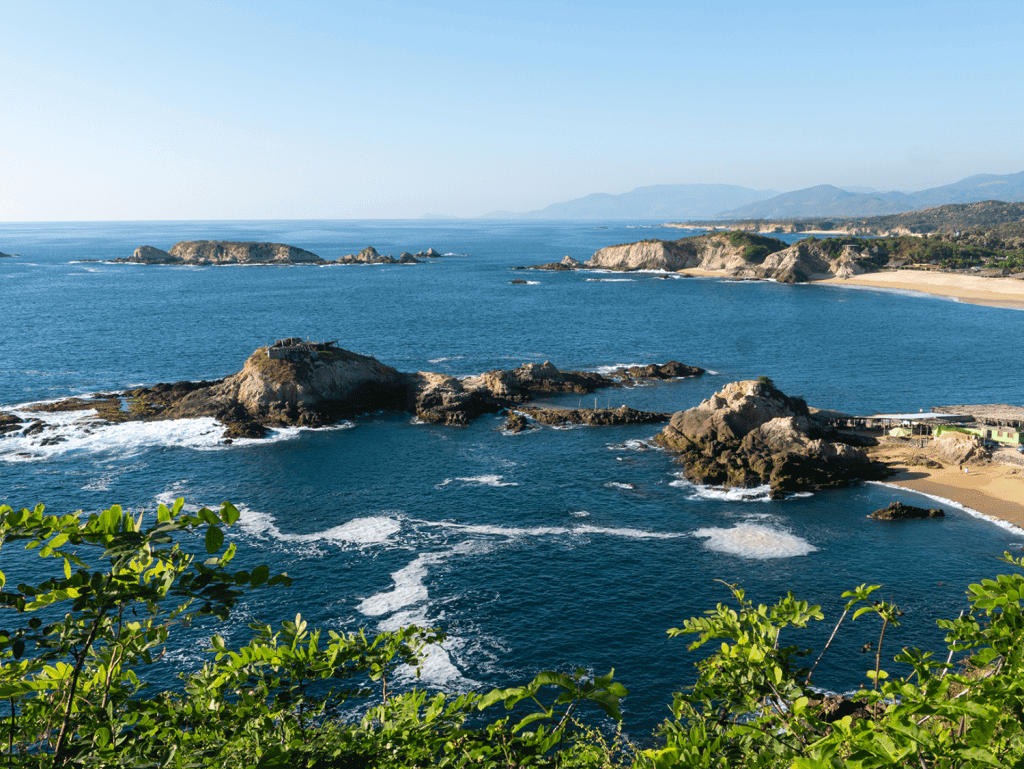 Beach coastline in Bucerias, Mexico with rocky formations and ocean views.