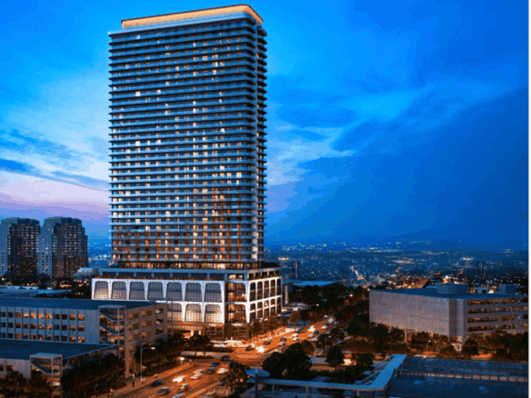 Fort Lauderdale high-rise building at dusk with city lights.