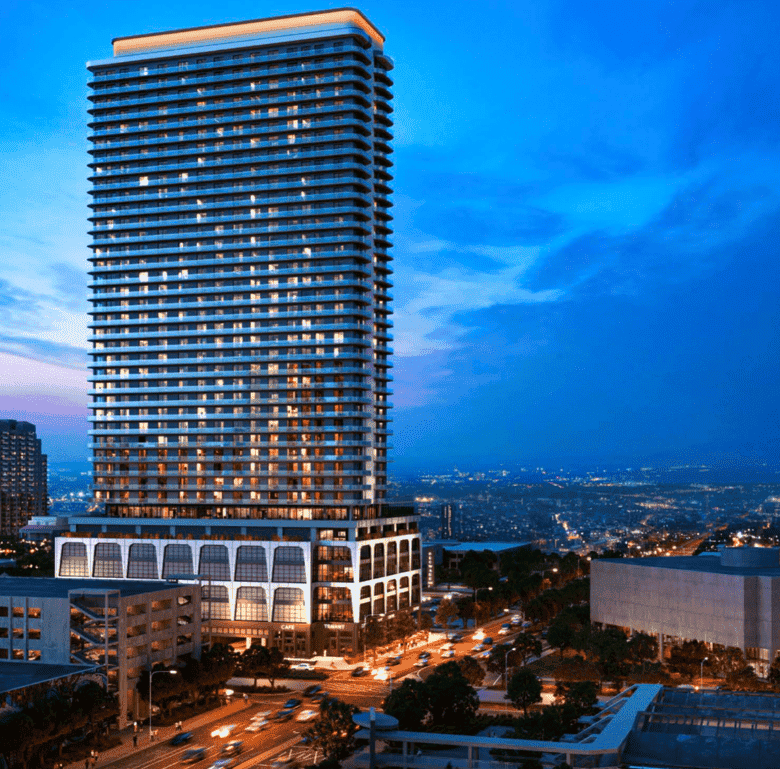 Fort Lauderdale high-rise building at dusk with city lights.