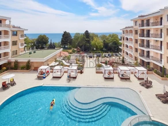 Balcony view of Valencia Gardens Nessebar with pool and sea in the background.