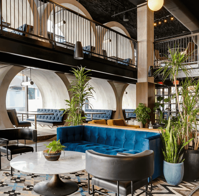 Chic hotel lobby with contemporary furniture, lush plants, and vibrant decor in Fort Lauderdale, USA.