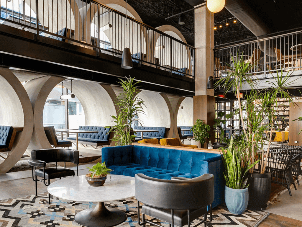 Chic hotel lobby with contemporary furniture, lush plants, and vibrant decor in Fort Lauderdale, USA.