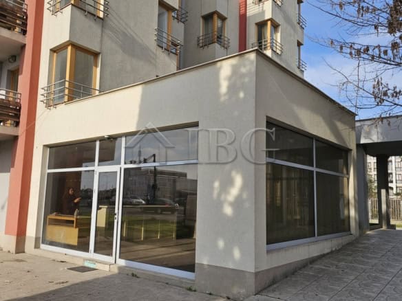 Commercial property with large glass windows in a busy urban area.