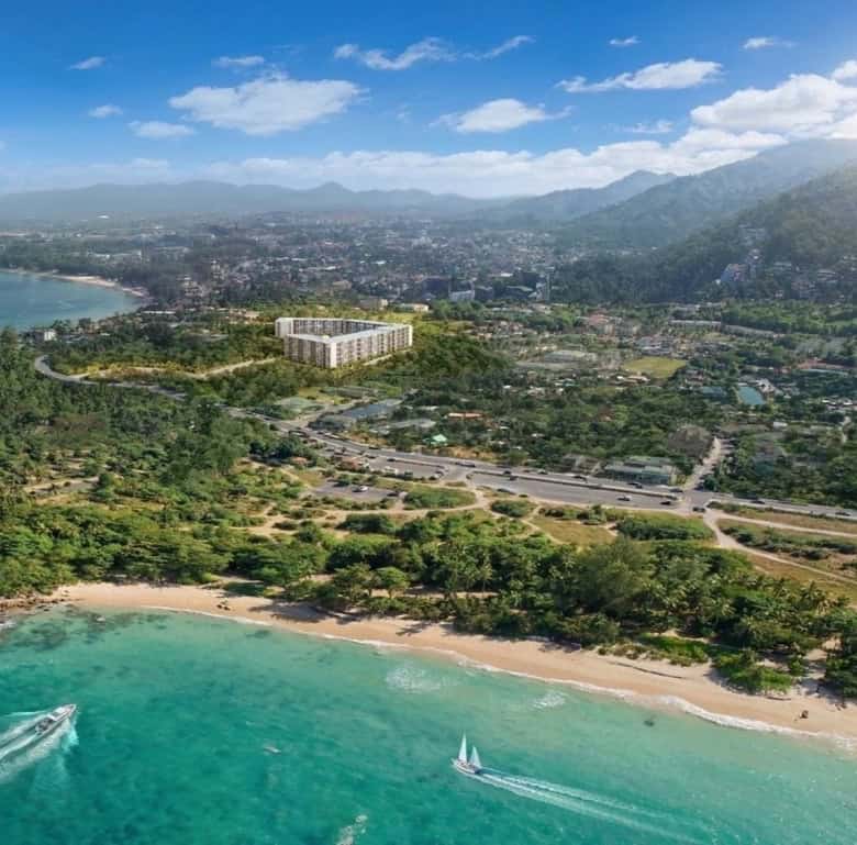 Beachfront view of Surin Beach with turquoise waters and lush greenery in Phuket, Thailand.