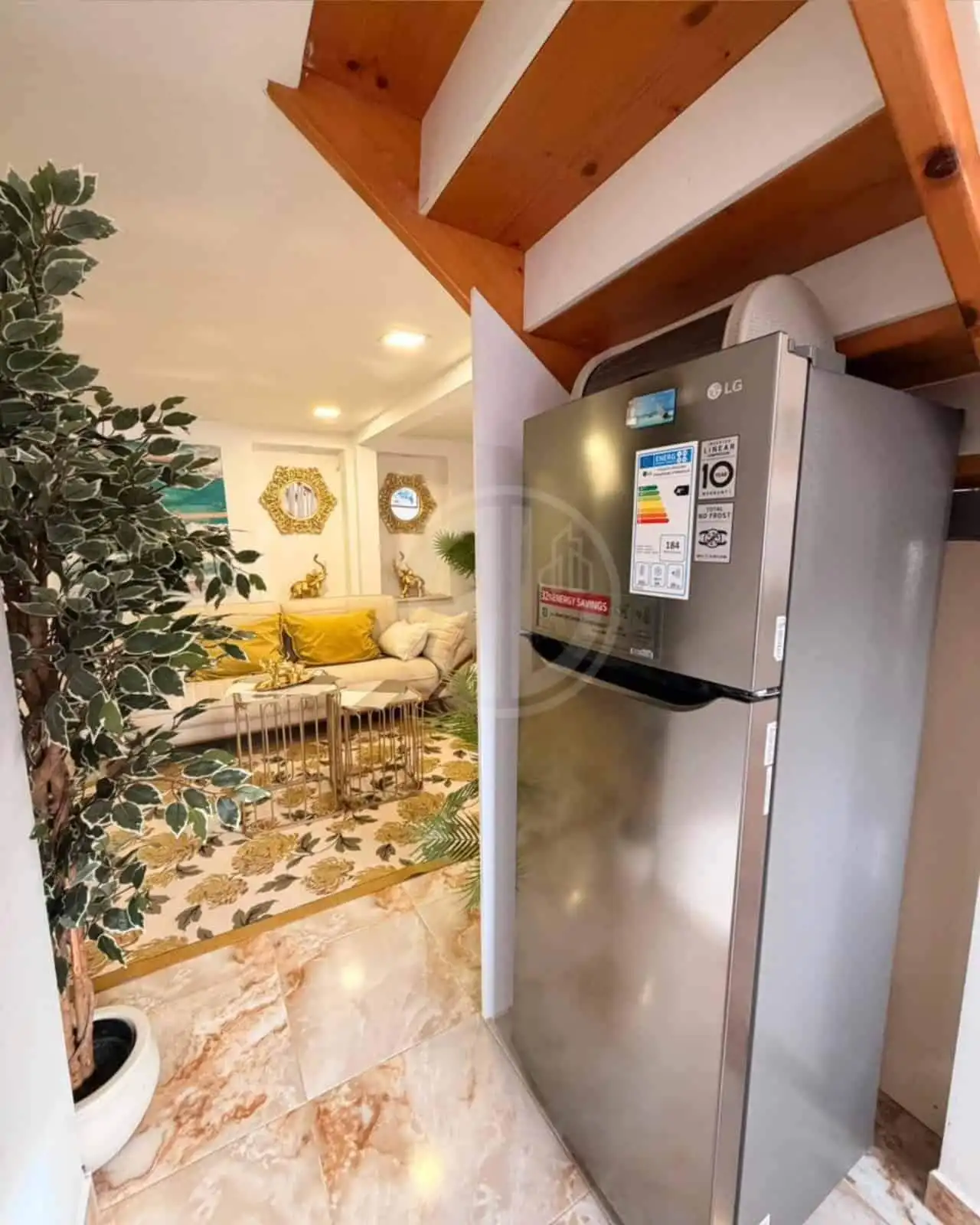 Stainless steel refrigerator in a warm, inviting living space with stylish decor and comfortable sea.