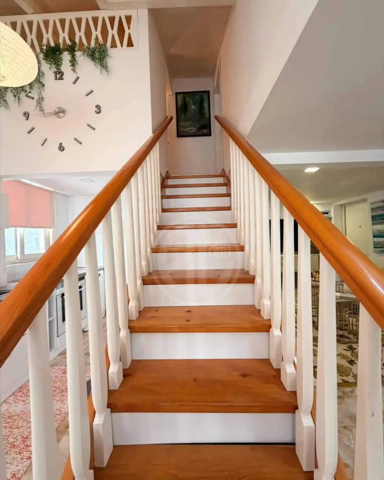 Cozy wooden staircase with white risers and natural wood treads in a bright, modern interior.