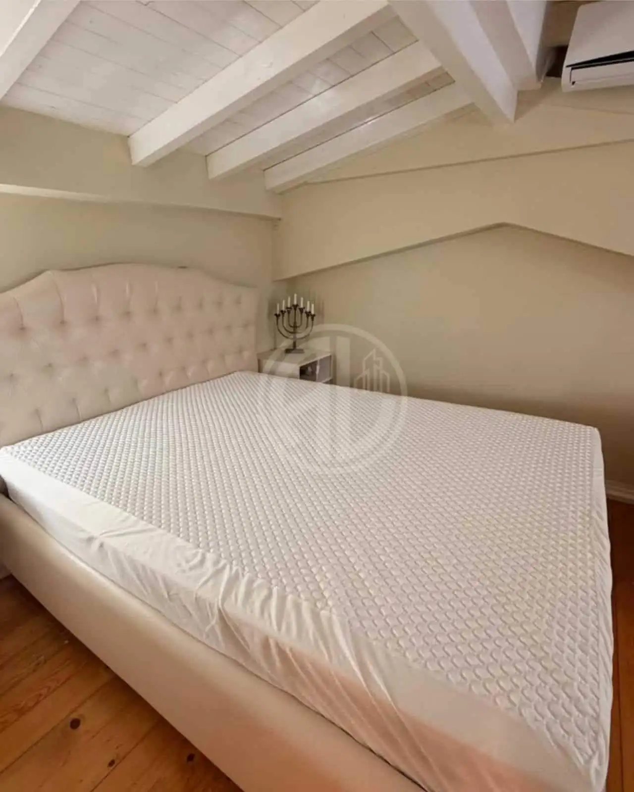 Comfortable bedroom featuring a sloped ceiling and cozy ambiance.