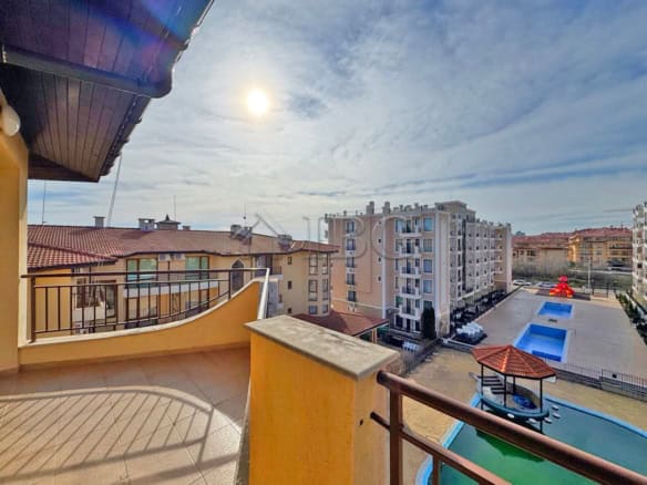 Bright balcony view of Sveti Vlas with modern buildings and swimming pools.