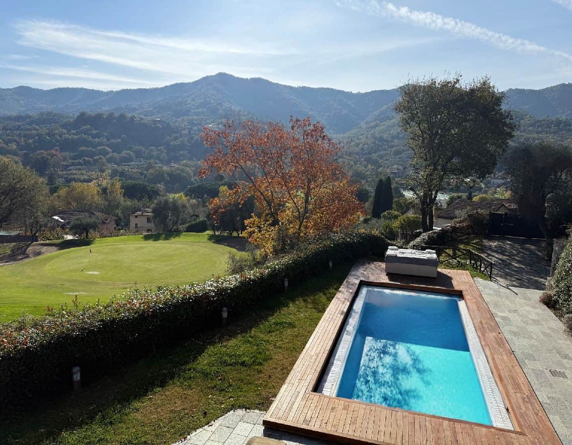 Luxury villa with private pool overlooking scenic mountains and lush greenery.