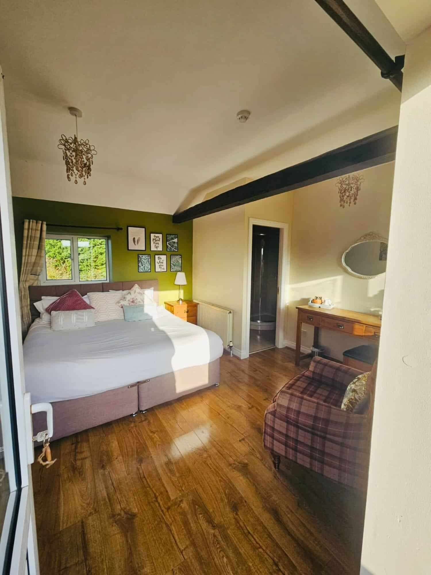 Cozy bedroom with vintage decor and wooden flooring Charming bedroom with vintage decor, wooden flooring, and natural light from the window.