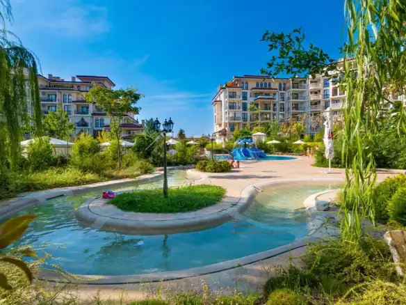 Modern apartment complex with lush gardens and pools in Nessebar, Bulgaria.