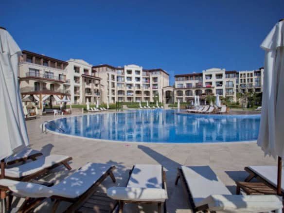 Spacious pool area with sun loungers and umbrellas at Green Life Beach Resort, Sozopol.