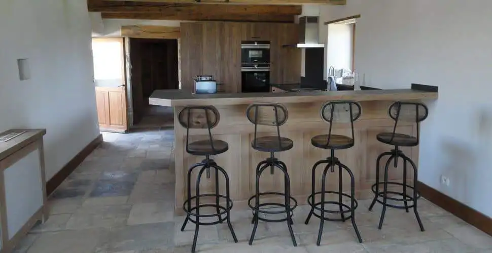 Elegant kitchen featuring a breakfast bar with four stylish stools in a luxurious French estate.