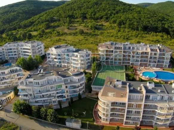 Aerial view of a modern apartment complex with garden access in Kosharitsa, Bulgaria.