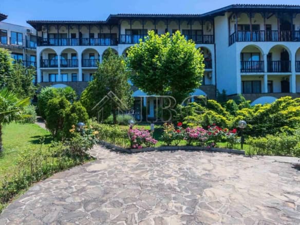 Bright view of Watermill Complex in Sveti Vlas with lush greenery and colorful flowers.