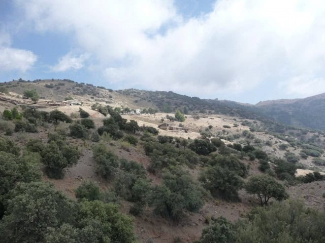 Scenic view of a rural estate in Caniles, Granada with rolling hills and lush greenery.