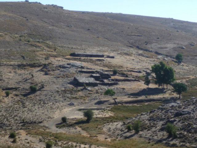 Scenic country estate with traditional buildings in Caniles, Granada, surrounded by rugged terrain a.