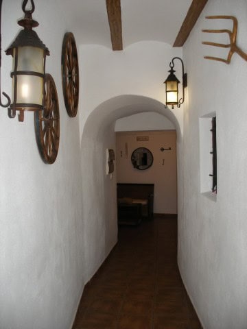 Cave house interior with rustic decor, lantern lighting, and wooden accents in Cuevas del Campo, Gra.