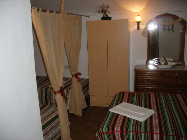 Cave house interior with rustic furniture and cozy decor in Cuevas del Campo, Granada. Unique underg.