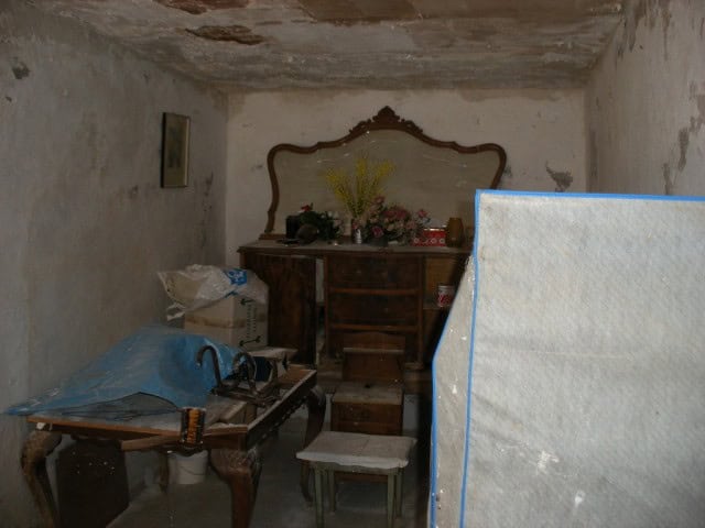 Charming interior of a historic cave house in Gorafe, Granada, showcasing rustic furniture and tradi.