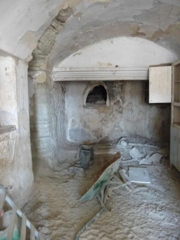 Rural property interior in Benamaurel, Granada, showing stone walls and rustic features.