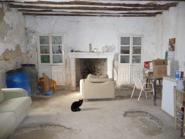 Cozy interior of a rural house in Benamaurel, Granada, featuring rustic decor and a fireplace.