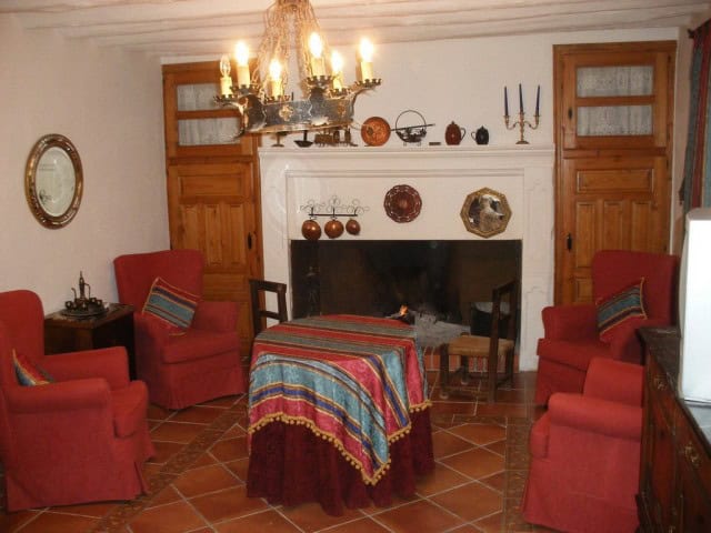 Charming interior of a village property in Benamaurel, Granada, featuring a fireplace, vintage furni.