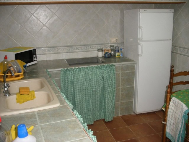 Charming village property in Benamaurel, Granada, featuring a cozy kitchen with a double sink and ba.