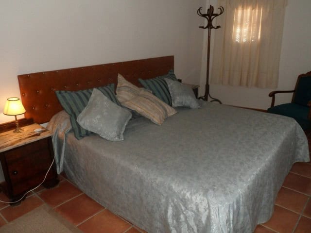 Charming bedroom in a traditional village property in Benamaurel, Granada, featuring a cozy bed and.