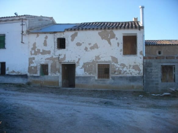 Charming village house in Venta del Peral, Granada, with rustic exterior and potential for renovatio.