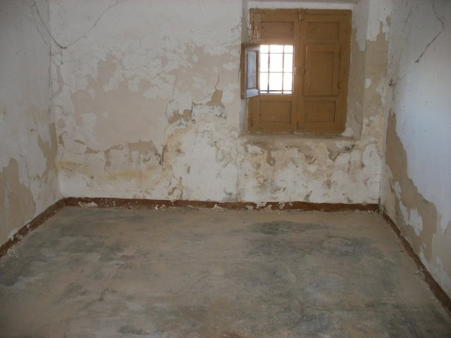 Village property interior with rustic charm in Venta del Peral, Granada, featuring weathered walls a.