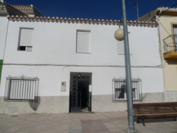 Charming village house in Cortes de Baza, Granada, featuring a white exterior and small balconies.