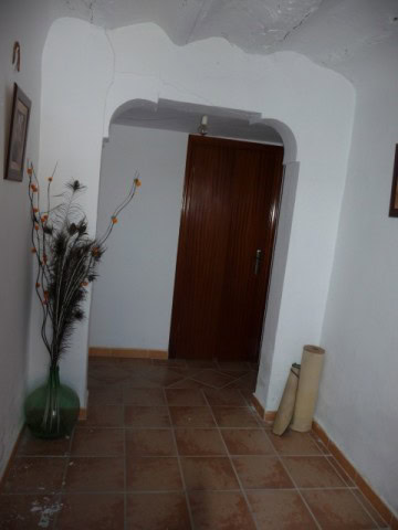 Village property entrance in Huesa, Jaen with wooden door and decorative interior.